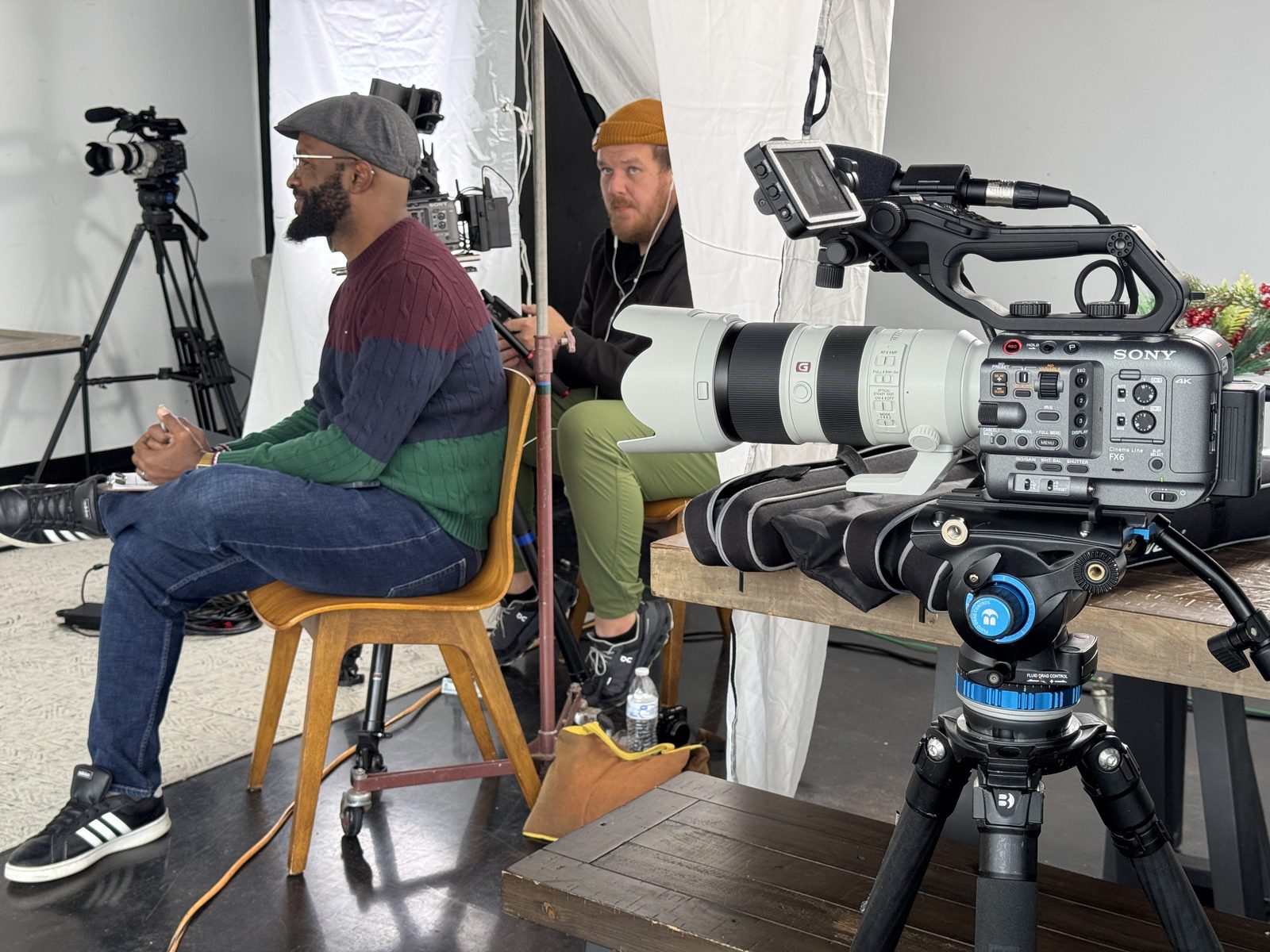 Operating a cinema camera with a telephoto long lens on a commercial set
