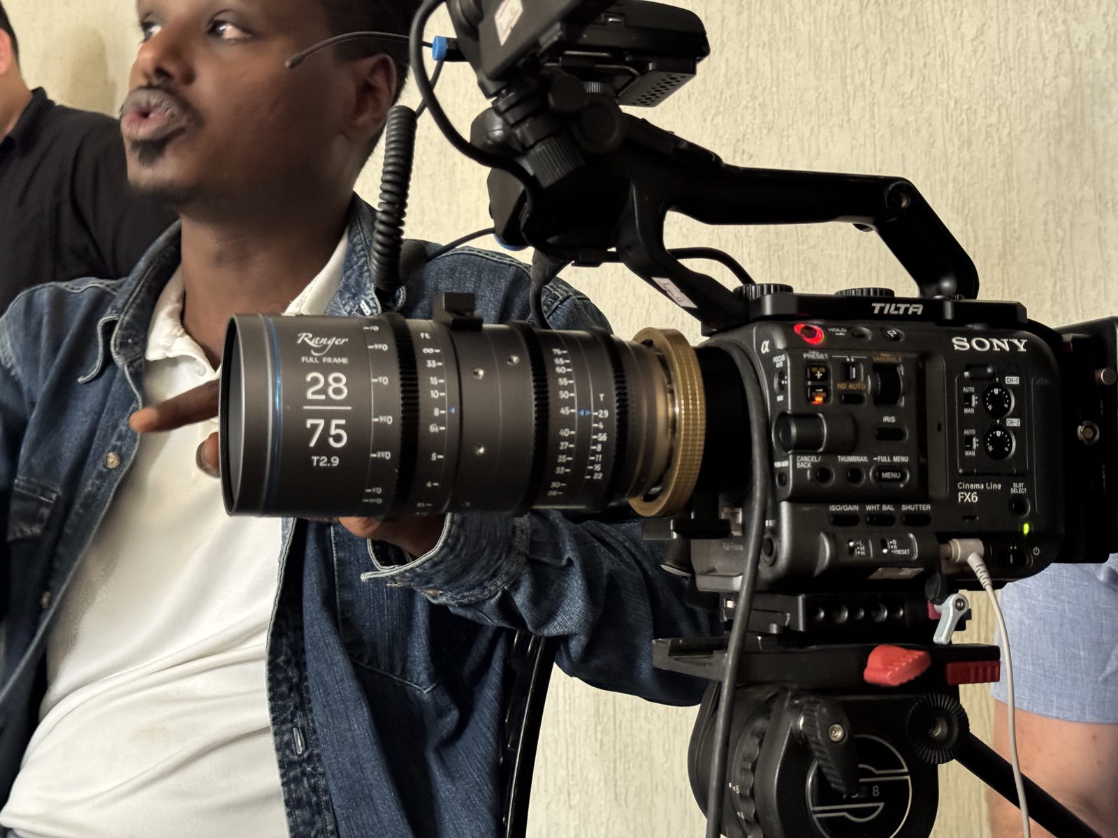 Two crew members lining up a shot on a cinema camera on location
