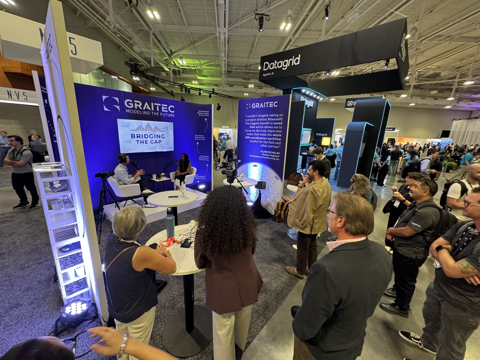 Live podcast and broadcast set filming on a busy conference show floor