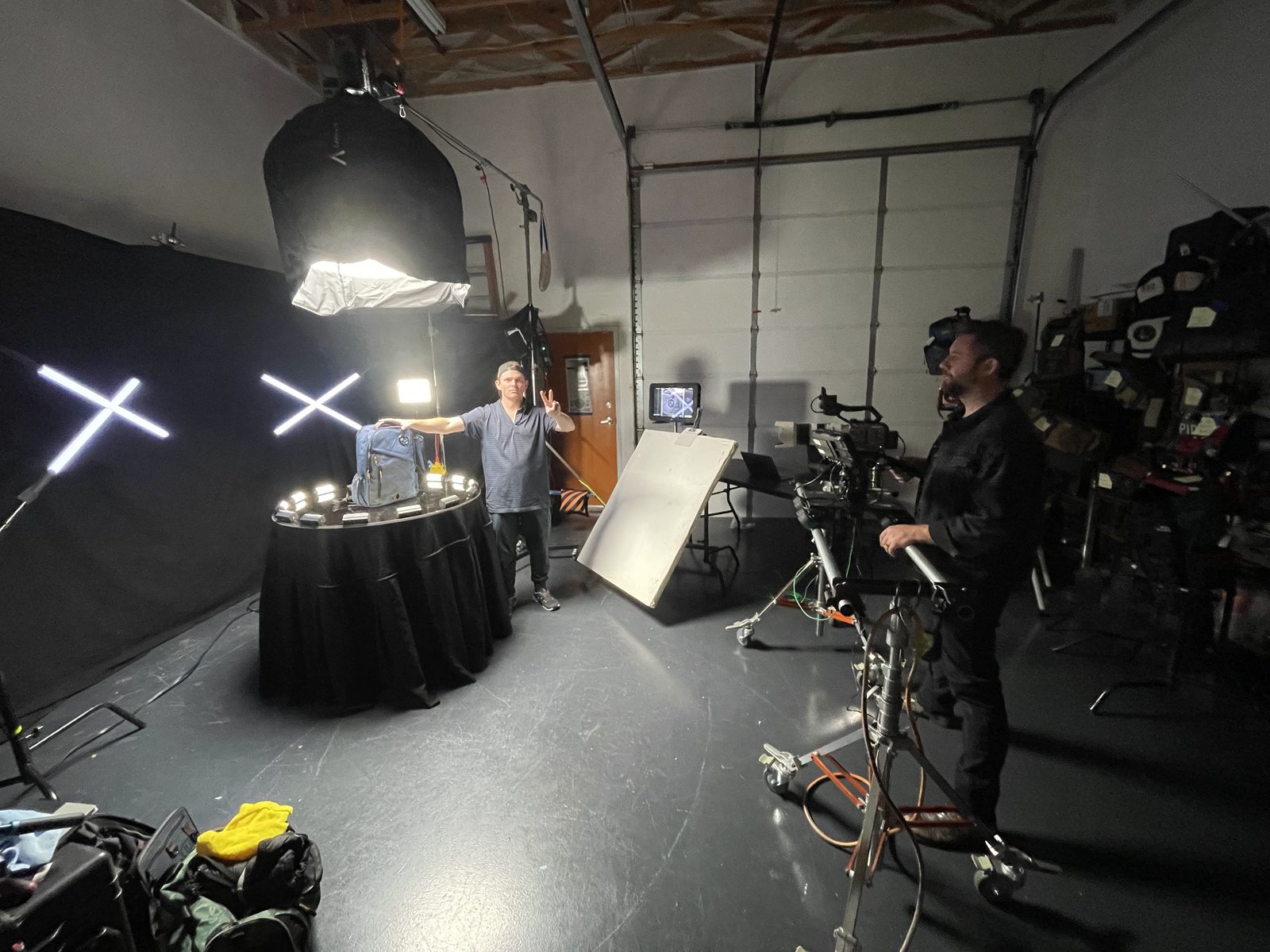 Tabletop product shoot in a black studio with crossed tube lights