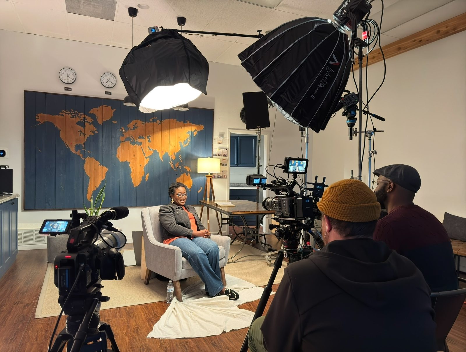 Cinematic multi-camera interview setup in a warmly lit corporate office